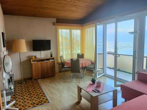 a living room with a table and a large window at Casa Franceschini in Locarno