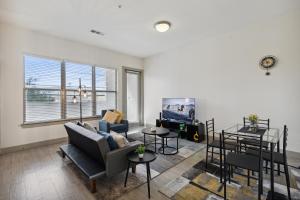 a living room with a couch and a tv at Stylish 1 Bedroom Apartment in Medical District in Dallas