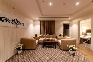 a living room with two couches and a table at Burj Al Hayat Hotel Suites - Al Olaya in Riyadh