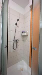 a bathroom with a shower with a glass door at Happy Living Apartment w Balcony in Budapest