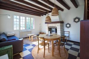 a living room with a table and a fireplace at Maison avec vue sur Loire proche de Chambord in Saint-Dyé-sur-Loire +34 photos