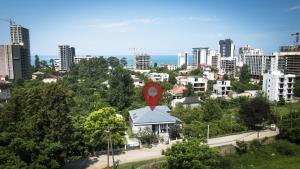 a city with a red marker on top of a building at Mziuri Guest House in Gonio