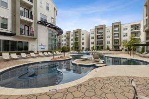an image of a swimming pool at a apartment complex at Stylish 1 Bedroom Apartment in Medical District in Dallas