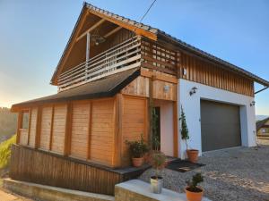 a wooden house with a garage at Apartament u Ewki in Rdzawka