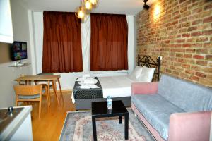 a living room with a couch and a brick wall at Sürmeli Butik House in Istanbul