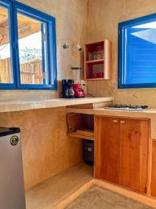 a kitchen with a counter and a sink and a window at Casa Omero Garden in El Cuyo