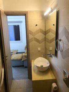 卡洛利瓦迪的住宿－Cycladic House with Aegean View，一间带水槽和镜子的浴室