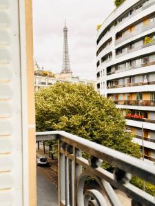 a view of the eiffel tower from the balcony of a building at Cosy appartement avec vue Tour Eiffel in Paris