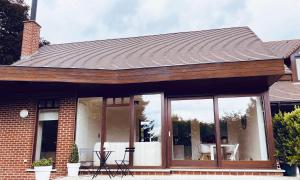 a house with sliding glass doors on it at Le Chalet du Pays de Herve in Herve