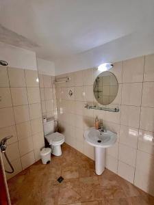 a bathroom with a toilet and a sink at DebiMar in Chernomorets