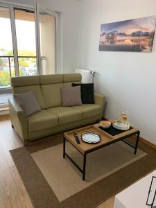 a living room with a couch and a coffee table at Panorama View of Krakow in Kraków