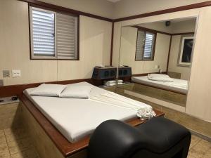 a bedroom with a large bed and a mirror at Motel Cigano’s in Belo Horizonte +16 photos