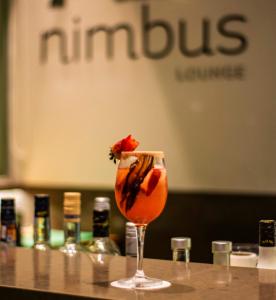 a drink with a strawberry in a glass on a table at Mercure Santiago Centro in Santiago