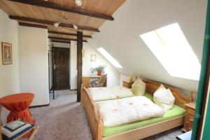 a bedroom with a bed and a skylight at Die Radler-Scheune Finsterbergen in Friedrichroda