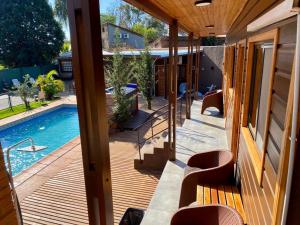 a view of a pool from a house with a porch at Hotel Amayal in Puerto Iguazú