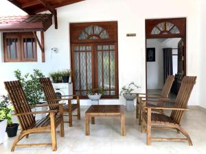 a group of chairs and a table on a patio at sands villa in Kandy