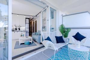 a living room with blue and white furniture at Apartament Baltic Porta Mare by Major Domus Club in Dziwnówek