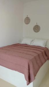 a white bedroom with a bed with a red blanket at suite diminutif 2 in Adamas