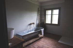 a bathroom with a tub in the corner of a room at Chaloupka Na Gruni in Hrádek