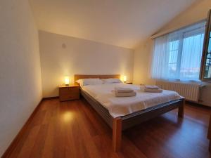 a bedroom with a bed with two towels on it at Apartments Renato in Zadar