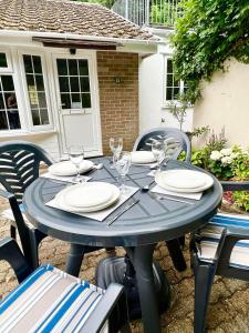 a blue table with plates and wine glasses on it at 14 Granite Henge in Looe