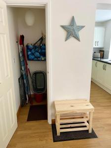 a hallway with a star sign on the wall and a table at 14 Granite Henge in Looe +18 photos