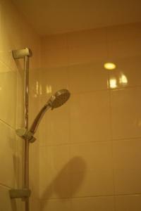 a shower with a shower head in a bathroom at Repton house in Woodford