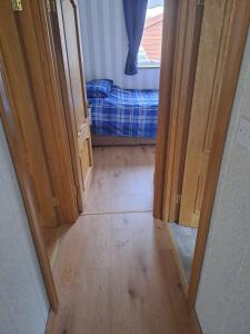 a hallway with a door open to a room with a bed at Willows Retreat in Dublin