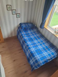 a bed in the corner of a room with a window at Willows Retreat in Dublin