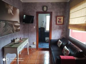 a living room with a couch and a table at La Buganvilla in Ribadesella