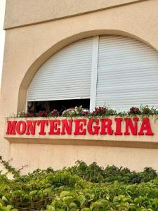 a sign on the side of a building with a window at Montenegrina Apartment in Budva