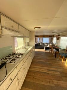 a kitchen with a sink and a stove top oven at Dulczetto Camp in Jastarnia