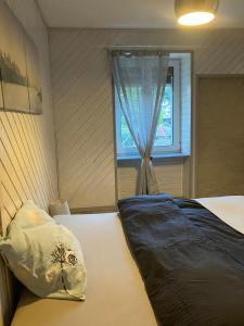 a bedroom with two beds and a window at Au numéro 12 