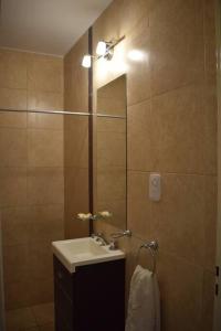 a bathroom with a sink and a mirror at Dpto cercano al centro con WIFI in San Luis +8 photos