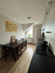a living room with a dining room table and chairs at Apartamenty Firfas Rodzinny 11 in Bydgoszcz