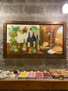 a painting of a table with wine bottles on it at Villa Tuiuty Pousada de Charme in Bento Gonçalves