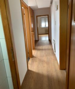 a hallway of a house with wooden floors and doors at Ferienwohnung Herborn in Herborn