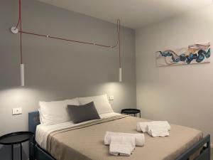 a bedroom with a bed with two towels on it at Porta San Paolo House in Castelbuono +43 photos