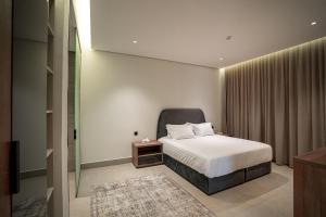 a hotel room with a bed and a window at Paradise of North Riyadh جنة شمال الرياض in Riyadh