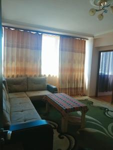 a living room with a couch and a table at City Center Cozy Apartment Tigran Mets in Yerevan