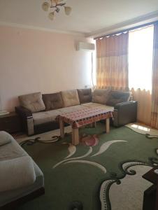 a living room with a couch and a coffee table at City Center Cozy Apartment Tigran Mets in Yerevan