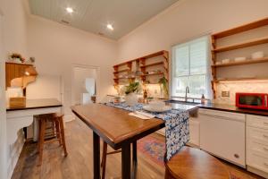 a kitchen with a wooden table and a counter top at Restored Home Near Downtown Thomasville in Thomasville