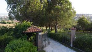 a black fence with a gate and trees at B&B La Figuretta in Iesi