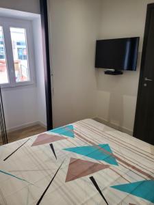 a room with a bed with a television on the floor at Chambre d'Hôte Straboni in Bastia