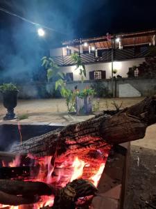 a fire pit in a courtyard at night at Cantinho da Vovó Lucinda in Diamantina +52 photos