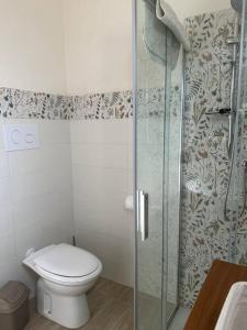 La salle de bains est pourvue de toilettes et d'une douche en verre. dans l'établissement LaMarticata-LikesHome StreetView, à Triscina