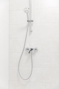 a shower with a shower head in a bathroom at VacationClub – Zdrojowa 7 Apartament 6 in Duszniki Zdrój