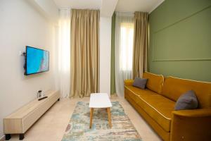 a living room with a couch and a table at Seaside Apartments in Vlorë