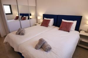 a bedroom with a large bed with towels on it at 2BDR Suite#Next To The Market#Best Location in Jerusalem