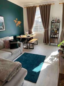 a living room with a couch and a table at One Bedroom Flat in the heart of Islington in London